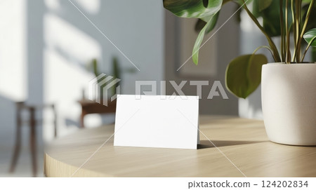 Stylish business card mockup placed on a polished wooden desk 124202834