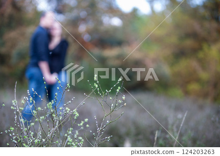 A loving couple embraces in the beauty and serenity of nature during an intimate moment 124203263