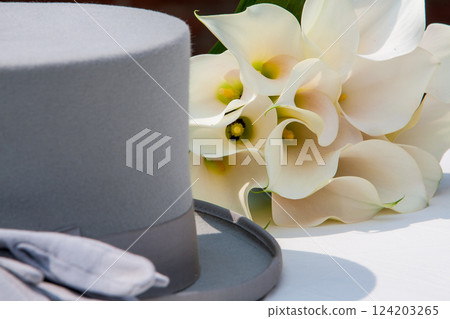 An Elegant Gray Hat paired with a White Calla Lily Bouquet creates a chic aesthetic 124203265