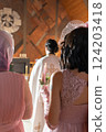 The girl holds a candle in her hand at the time of the wedding. 124203418