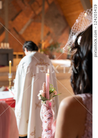 View of the wedding from the back. The priest conducts the ceremony. View of the wedding from the back. The priest conducts the ceremony. 124203419