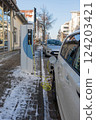An electric car on the street is being charged in Germany. 124203421