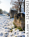 Vertical photo of a snow-covered sidewalk in the city. 124203423