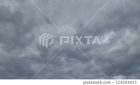 Blue sky with clouds, winter weather. Clouds on the background of trees. Blue sky with clouds, winter weather. Clouds on the background of trees. 124203453