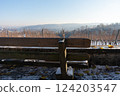 An empty wooden bench with a beautiful view of nature. 124203547