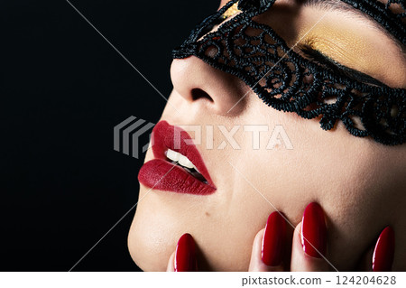Woman face with lace mask red lips and red nails Woman face with lace mask red lips and red nails 124204628