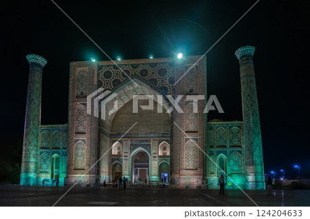 Ulugbek Madrasah on Registan Square with festive evening color lighting. Samarkand, Uzbekistan. 124204633