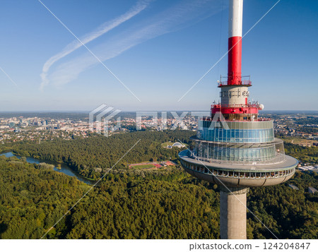 Close-up view of a telecommunications tower with an observation deck. Modern architecture and panoramic cityscape in the background 124204847