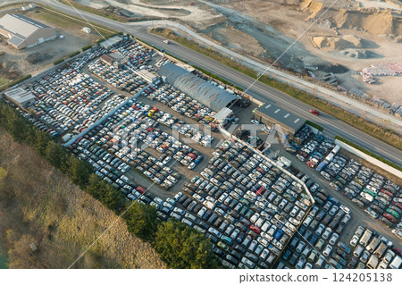 Aerial view of big parking lot of junkyard with rows of discarded broken cars. Recycling of old vehicles 124205138