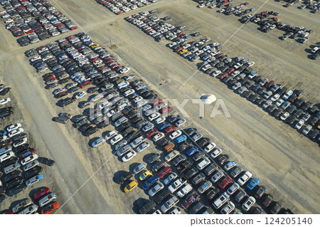Aerial view of auction reseller company big parking lot with parked cars ready for remarketing services. Sales of secondhand vehicles Aerial view of auction reseller company big parking lot with parked cars ready for remarketing services. Sales of secondhand vehicles 124205140