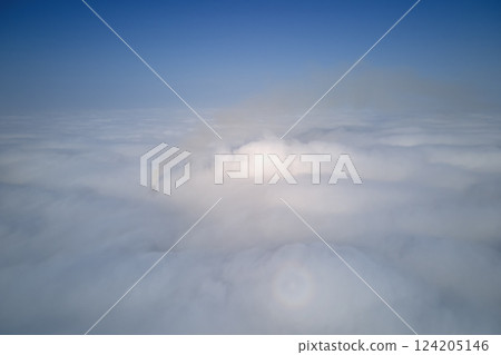 Aerial view from high altitude of earth covered with puffy rainy clouds forming before rainstorm 124205146