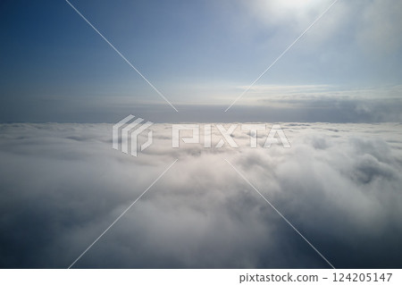 Aerial view from high altitude of earth covered with puffy rainy clouds forming before rainstorm 124205147