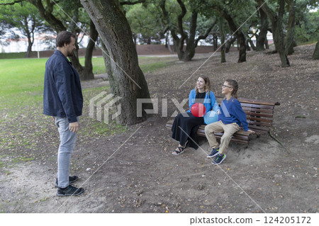 Family enjoying time together in park with balloons Family enjoying time together in park with balloons 124205172