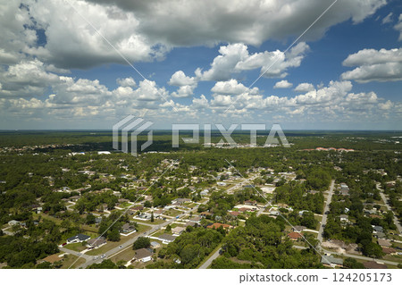 Aerial landscape view of suburban private houses between green palm trees in Florida quiet rural area Aerial landscape view of suburban private houses between green palm trees in Florida quiet rural area 124205173