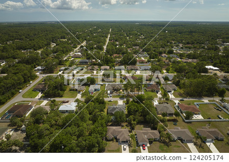 Aerial landscape view of suburban private houses between green palm trees in Florida quiet rural area Aerial landscape view of suburban private houses between green palm trees in Florida quiet rural area 124205174