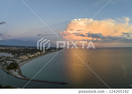 Aerial evening seascape with Nokomis sandy beach in Sarasota County, USA. Many tourists enjoing summer vacation time swimming in warm Mexico gulf water and sunbathing on hot Florida sun Aerial evening seascape with Nokomis sandy beach in Sarasota County, USA. Many tourists enjoing summer vacation time swimming in warm Mexico gulf water and sunbathing on hot Florida sun 124205192