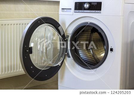 A close up of open washing machine in bathroom A close up of open washing machine in bathroom 124205203