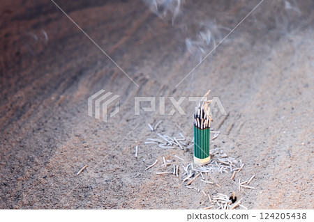 Close-up of burning incense in fine sand, with soft smoke rising into the air Close-up of burning incense in fine sand, with soft smoke rising into the air 124205438