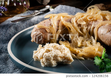 Fried white sausage with onions. 124206156