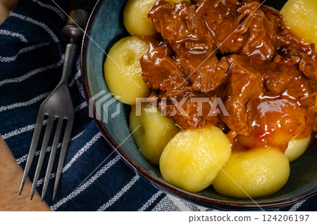 Beef stew in gravy, served with silesian dumplings. Beef stew in gravy, served with silesian dumplings. 124206197