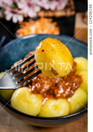 Beef stew in gravy, served with silesian dumplings. Beef stew in gravy, served with silesian dumplings. 124206198