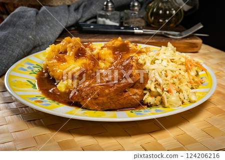 Braised pork ribs with spicy sauce served with mashed potatoes and salad. 124206216