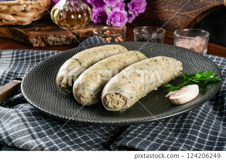 Three cooked white sausages on a plate. Three cooked white sausages on a plate. 124206249