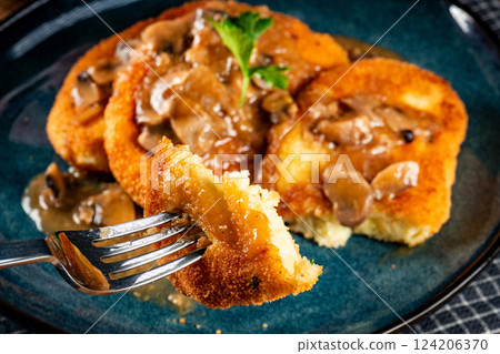 Potato cutlets with mushroom sauce. 124206370