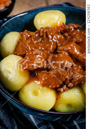 Beef stew in gravy, served with silesian dumplings. Beef stew in gravy, served with silesian dumplings. 124206561