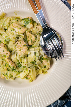 Tasty pasta with spinach and sliced chicken. Tasty pasta with spinach and sliced chicken. 124206567