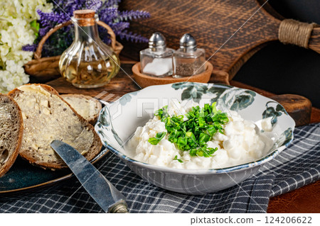 Slices of bread with cottage cheese and green onion. 124206622