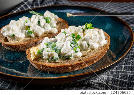 Slices of bread with cottage cheese and green onion. Slices of bread with cottage cheese and green onion. 124206623