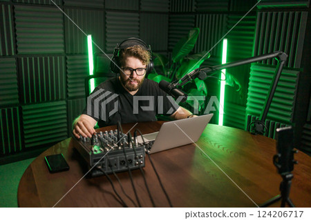 Handsome man radio DJ hosting a radio show, entertainment and communication concept 124206717