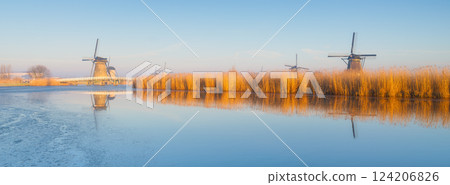 Windmills in the Netherlands during sunrise. Foggy morning. Windmills in the Netherlands during sunrise. Foggy morning. 124206826