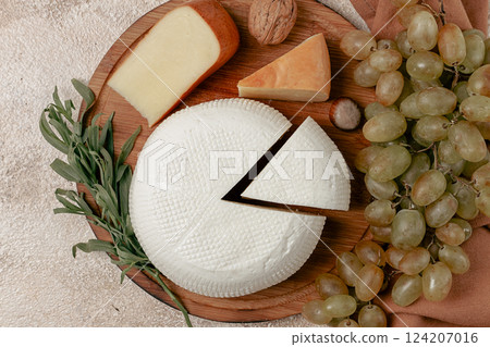 Georgian cheese, Imeretian and smoked suluguni, grapes, nuts, on a cutting board, Georgian cuisine, no people, 124207016