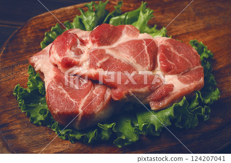 raw pork steak, two pieces, on a wooden background, 124207041