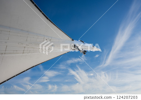 front part of supersonic passenger airliner against blue sky view from below front part of supersonic passenger airliner against blue sky view from below 124207203
