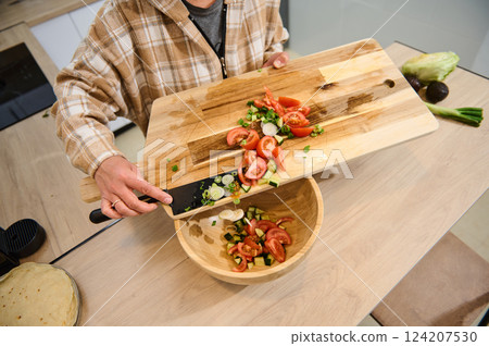 Preparing a Fresh Salad in a Cozy Home Kitchen Environment Preparing a Fresh Salad in a Cozy Home Kitchen Environment 124207530