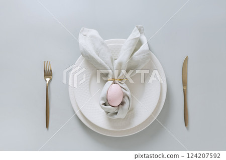 Easter spring table setting with pink egg on gray background. Happy creative Easter decoration. View from above. Easter spring table setting with pink egg on gray background. Happy creative Easter decoration. View from above. 124207592