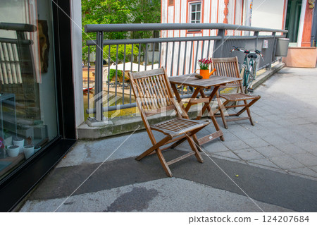 Cafe on the open air. Chairs and tables outside on the summer sun weather in Germany near the river. Design of furnitureset for summer cafe or restaurant. 124207684