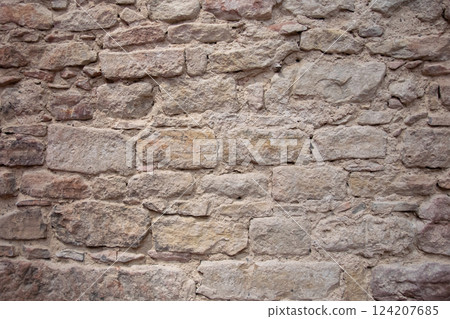Structural stone wall of the ancient building consists of old bricks. Nature structural background. 124207685