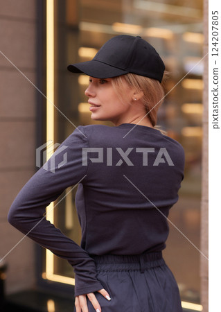 Young fashion blond woman in city park Stylish female model in white long sleeve shirt 124207805