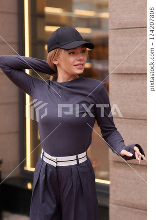 Young fashion blond woman in city park Stylish female model in white long sleeve shirt 124207808