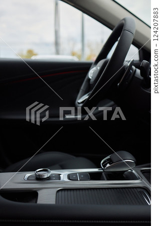 Selector automatic transmission with leather in the interior of a modern expensive car. The background is blurred. Black and brown leather car. Selector automatic transmission with leather in the interior of a modern expensive car. The background is blurred. Black and brown leather car. 124207883
