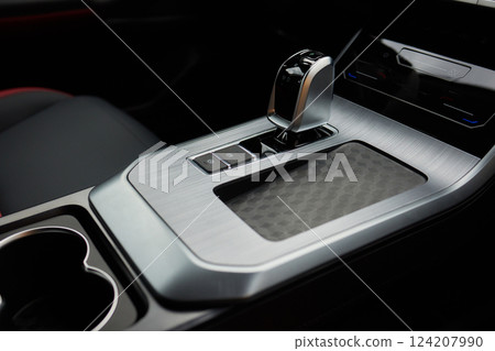 Selector automatic transmission with leather in the interior of a modern expensive car. The background is blurred. Black and brown leather car. 124207990