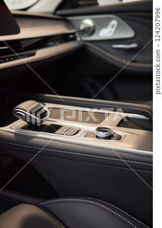 Selector automatic transmission with leather in the interior of a modern expensive car. The background is blurred. Black and brown leather car. 124207996