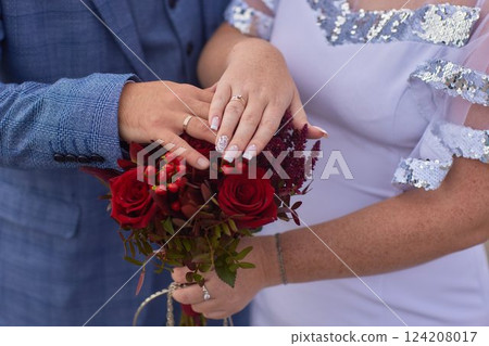 Close-up photo of the men s holding woman hand with golden wedding ring with diamond. Wedding ring before the proposal. Luxury wedding rings Close-up photo of the men s holding woman hand with golden wedding ring with diamond. Wedding ring before the proposal. Luxury wedding rings 124208017