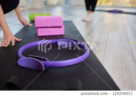 Empty, bright Yoga studio with mats and foam blocks. Wooden floor. 124208051