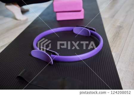 Empty, bright Yoga studio with mats and foam blocks. Wooden floor. 124208052