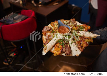 Assorted kebabs on board with red onion 124208060